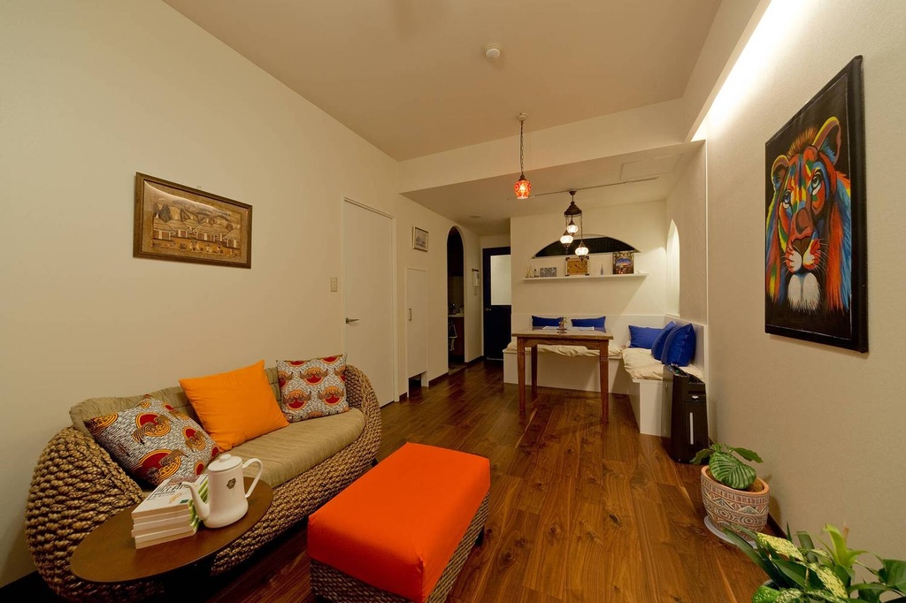 hacorenove style interior, Japanese modern open-plan kitchen-living room, oak wood flooring, curved wooden slat partition, arched doorway, white tile backsplash, concrete accents, track lighting, minimalist warm atmosphere