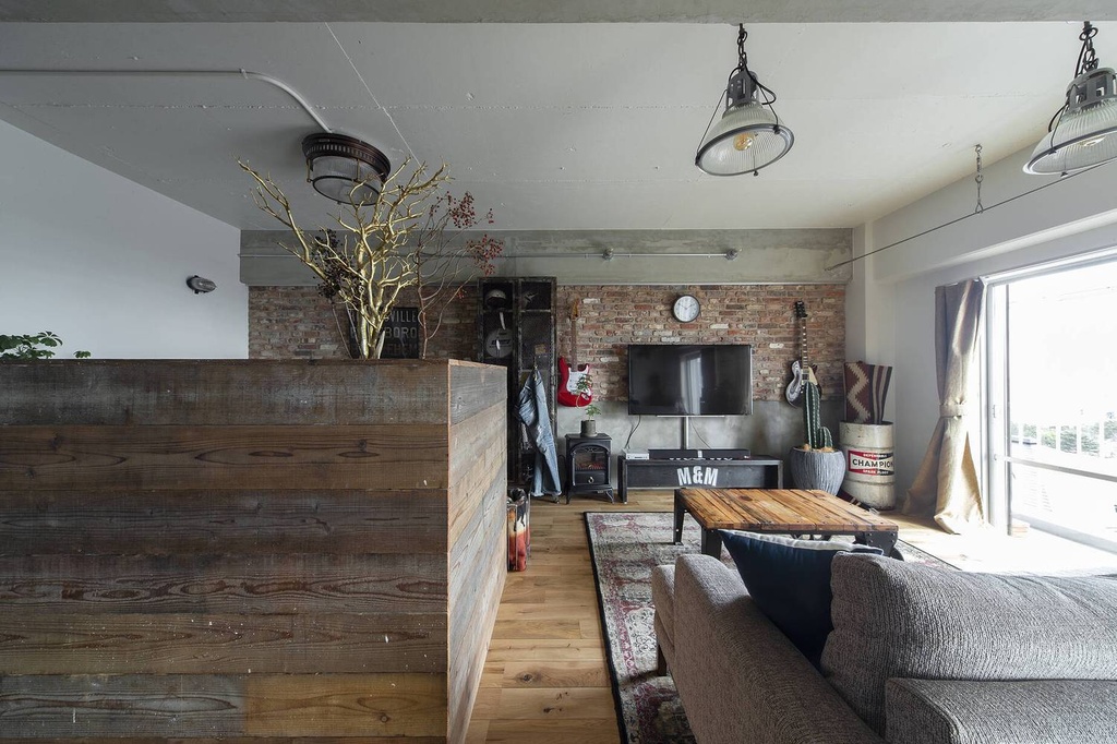hacorenove style interior, open-plan studio apartment, exposed concrete ceiling, industrial ductwork, light oak hardwood floors, hanging hammock, rattan furniture, linen bedding, natural greenery, soft diffused daylight, Japanese industrial-bohemian atmosphere