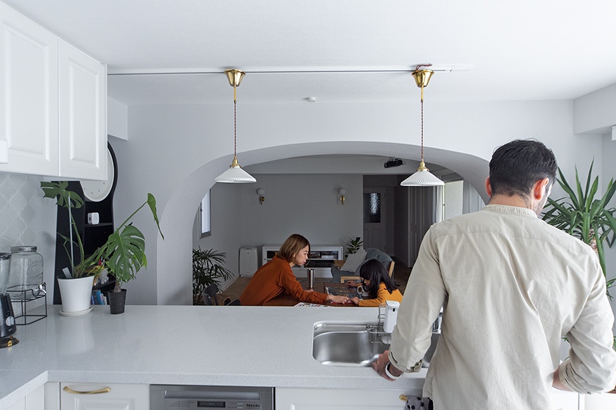 hacorenove style interior, minimalist Japanese apartment dining kitchen, exposed concrete ceiling, gray tile flooring, white walls, wooden dining table, pendant lights, natural daylight, indoor plants, industrial-modern aesthetic